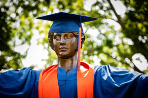 Alma Mater in a cap and gown.